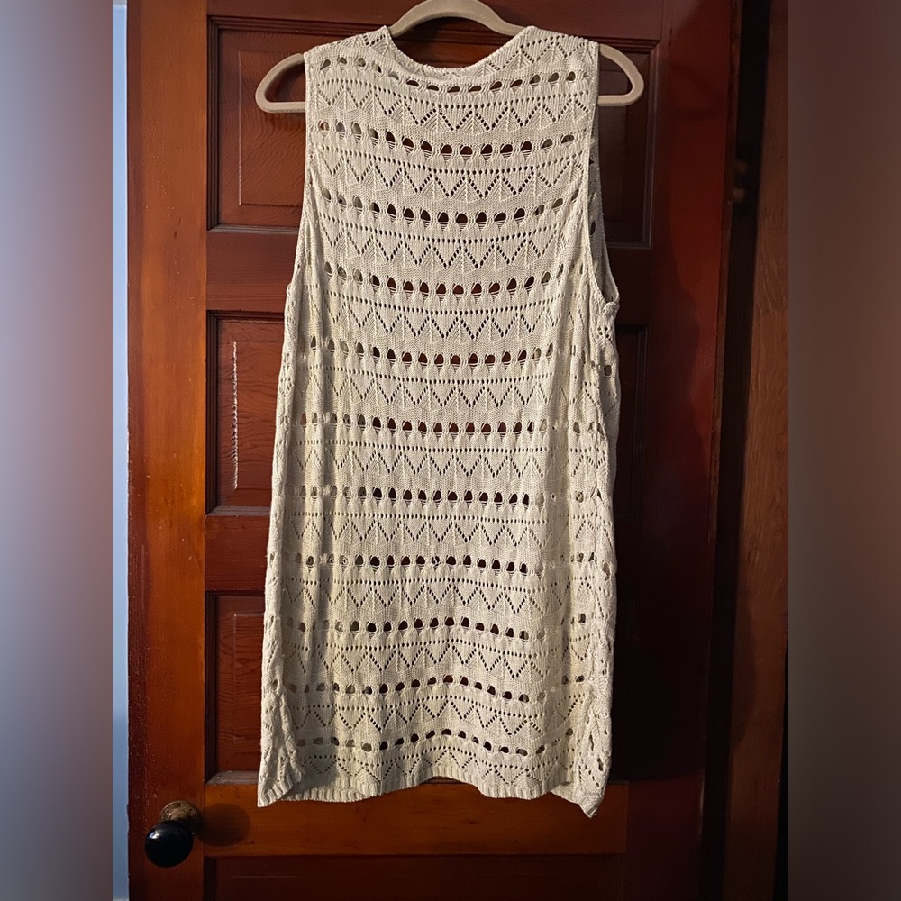 Long sleeveless open duster-like cardigan.
